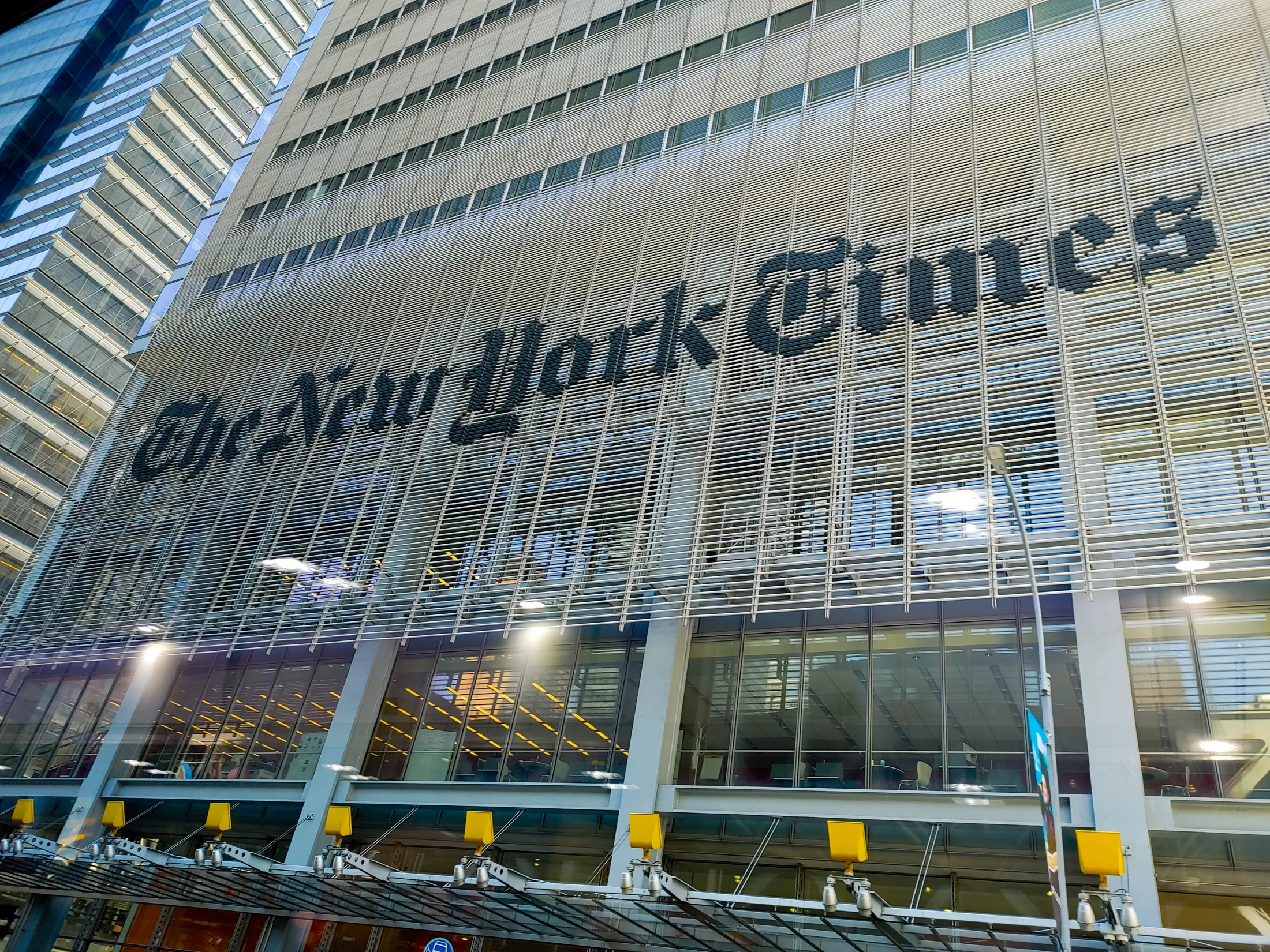 The New York Times name spanning the metal screen of its Manhattan building